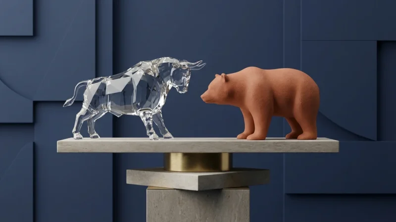 A crystal bull and clay bear statue facing each other on a stone pedestal.